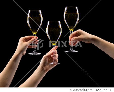 Set of hands holding white wine glass isolated on black. 65306585