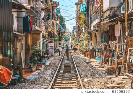 Woman is making a picture of Hanoi city railway Perspective view running along narrow street with houses in Vietnam 65306593