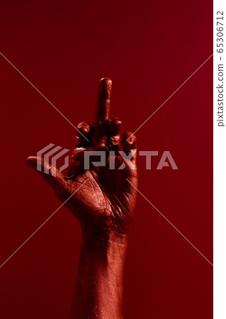 Red painted hand showing middle finger gesture Red painted hand showing middle finger gesture 65306712