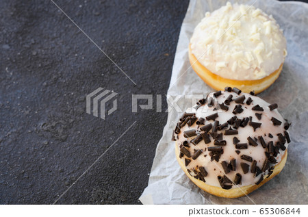 Traditional donut day. Assorted donuts with chocolate glazed on wooden background. Traditional donut day. Assorted donuts with chocolate glazed on wooden background. 65306844