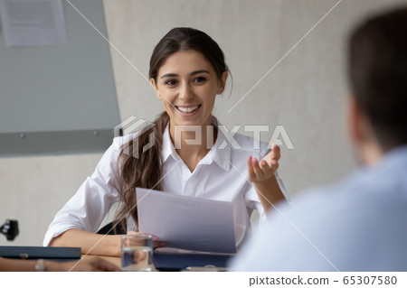 Close up happy young businesswoman holding finance document talking. Close up happy young businesswoman holding finance document talking. 65307580