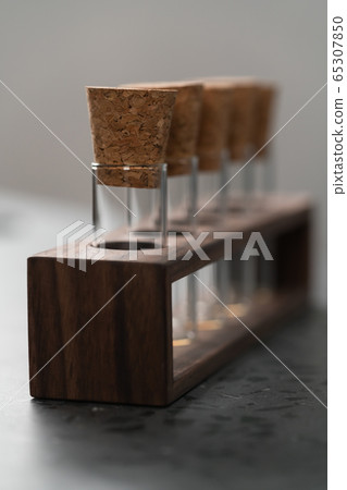 empty walnut holder with glass tubes for spices on concrete surface 65307850
