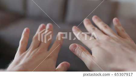 pov shot of man showing clean hands after applying sanitizer gel to his hands closeup 65307917