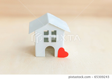 Miniature toy model house with red heart on wooden Miniature toy model house with red heart on wooden 65309243