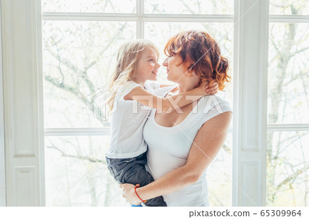 Stay Home Stay Safe. Young mother holding her Stay Home Stay Safe. Young mother holding her 65309964