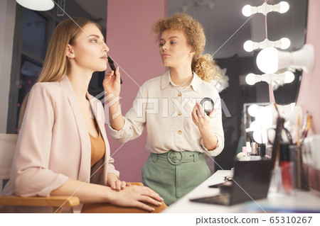 Young Make up Artist Working with Model 65310267