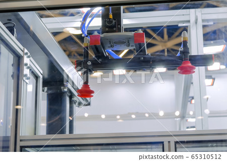 Automatic robotic arm manipulator with suction cups at plant - close up Automatic robotic arm manipulator with suction cups at plant - close up 65310512