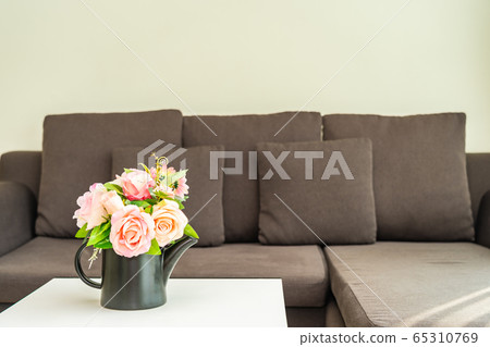 Vase flower on table with pillow and sofa decoration interior Vase flower on table with pillow and sofa decoration interior 65310769