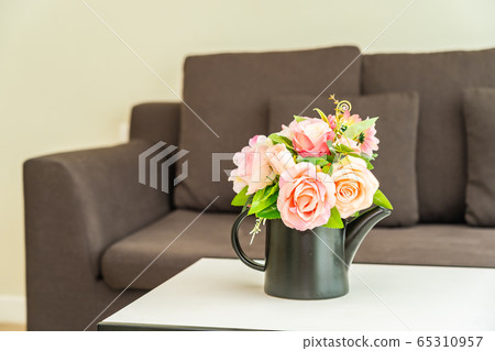 Vase flower on table with pillow and sofa decoration interior 65310957