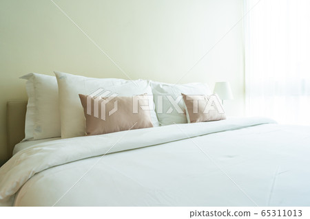 White comfortable pillow on bed decoration interior White comfortable pillow on bed decoration interior 65311013