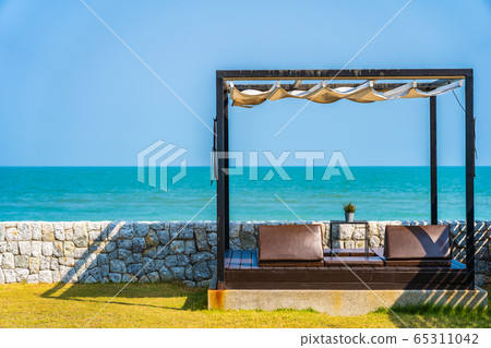 Pillow on sofa bed with lounge around beach ocean sea and blue sky Pillow on sofa bed with lounge around beach ocean sea and blue sky 65311042