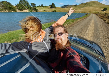 Car journey enjoying sunroof in the countryside Car journey enjoying sunroof in the countryside 65313313