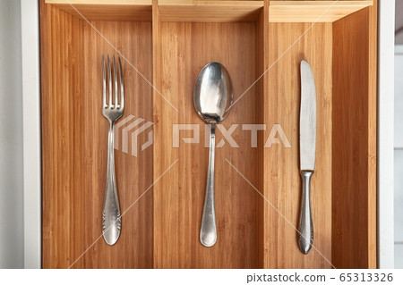 Minimalist kitchen tools put away in a drawer 65313326