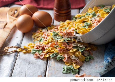 dry pasta on rustic wood and fresh eggs 65313872