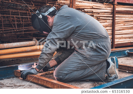 Welding work, Man Welding in Workshop. Metalwork and Sparks. Construction an Industrial concept. Welding work, Man Welding in Workshop. Metalwork and Sparks. Construction an Industrial concept. 65316530