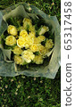 A beautiful yellow bouquet on a green lawn 65317458