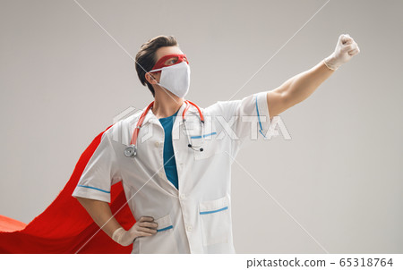 Doctor wearing facemask and superhero cape Doctor wearing facemask and superhero cape 65318764