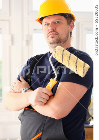 Smiling worker hold brush portrait 65320035