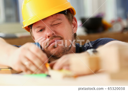 Arms of worker measuring wooden bar portrait Arms of worker measuring wooden bar portrait 65320038