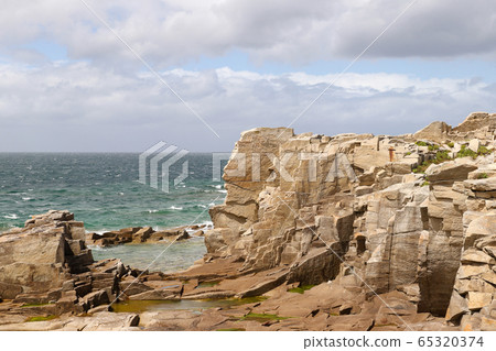 Cliffs on the coast of the Ile Grande in Brittany 65320374