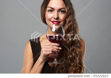 happy smiling woman with glass of wine 65322823