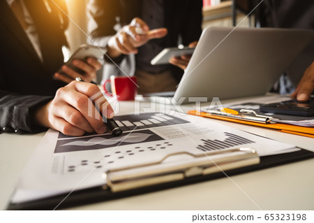 Business team meeting. professional investor working new start up project. Finance task. with smart phone and laptop and digital tablet computer  in morning light 65323198