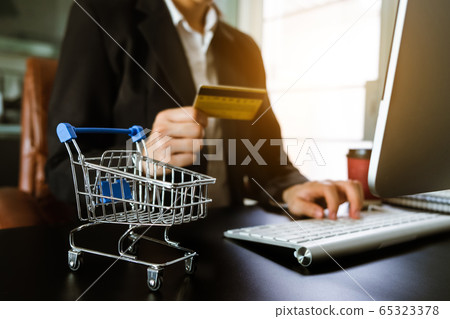 Business woman hands using smartphone and holding credit card with digital layer effect diagram as Online shopping concept Business woman hands using smartphone and holding credit card with digital layer effect diagram as Online shopping concept 65323378