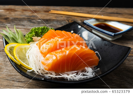 Sashimi, Salmon, Japanese food chopsticks and wasabi on the wood table Sashimi, Salmon, Japanese food chopsticks and wasabi on the wood table 65323379