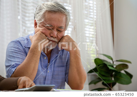 Asian senior man thinking about something and Asian senior man thinking about something and 65323450