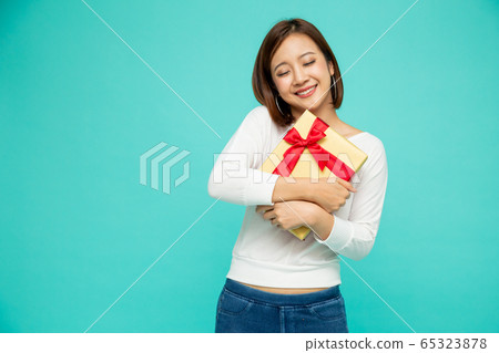 Happy beautiful asian woman smile with gold gift 65323878