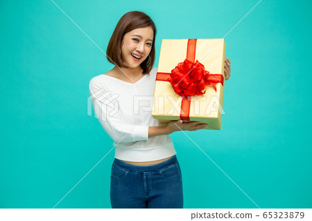 Happy beautiful asian woman smile with gold gift Happy beautiful asian woman smile with gold gift 65323879
