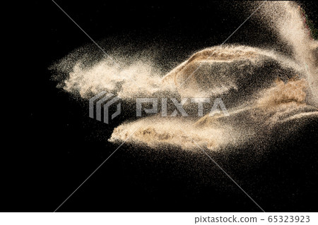 Brown sand explosion isolated on black background. Brown sand explosion isolated on black background. 65323923