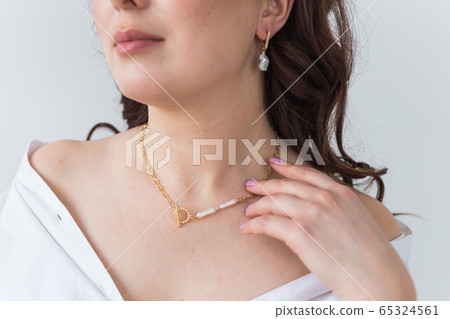 Close-up of woman wearing a Jewelry, bijouterie and accessories. Close-up of woman wearing a Jewelry, bijouterie and accessories. 65324561