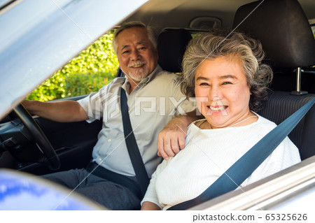 Asian senior couple driving a car and smile 65325626