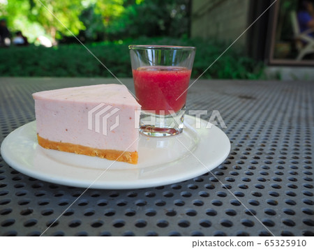 Slice of plain cheesecake with cranberry sauce on 65325910