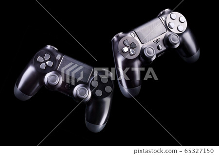 Set of black video game joysticks gamepad isolated on a black background Set of black video game joysticks gamepad isolated on a black background 65327150