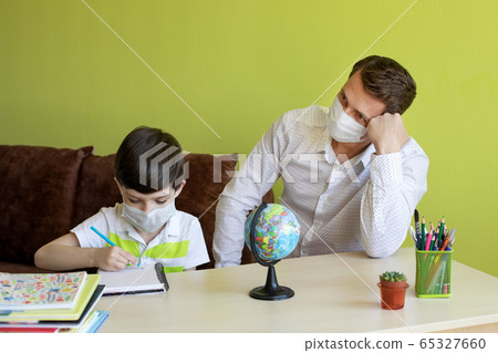 Boy with father doing homework during the coronavirus quarantine. 65327660