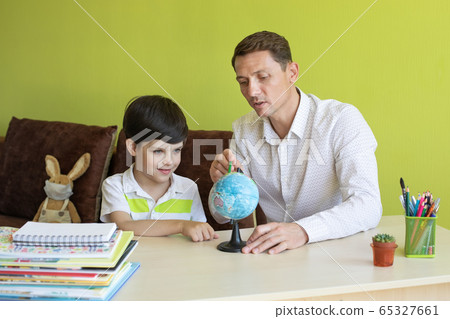 Boy with father doing homework during the coronavirus quarantine. 65327661
