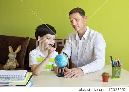 Boy with father doing homework during the coronavirus quarantine. 65327662