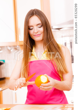Woman peeled orange fruit with knife Woman peeled orange fruit with knife 65328299