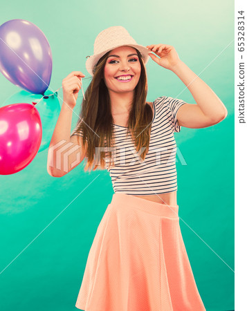 Woman summer joyful girl with colorful balloons 65328314