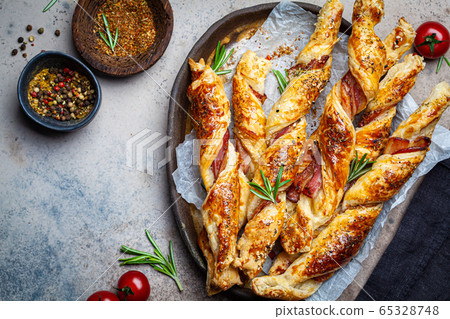 Crispy bread sticks with cheese, bacon and spices. Crispy bread sticks with cheese, bacon and spices. 65328748