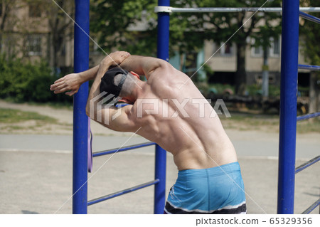 strong man stretching his body 65329356