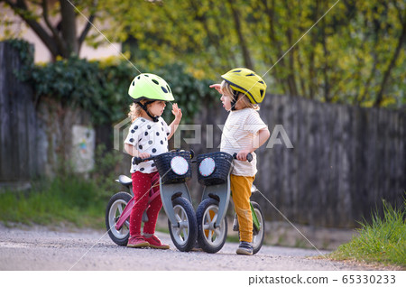 Small children boy and girl with helmets and Stock Photo