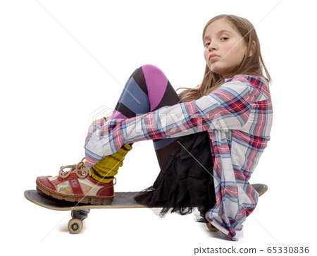 pretty young girl sitting on skate, on white 65330836