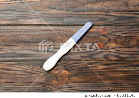 Colored Pregnancy test on wooden background, top Colored Pregnancy test on wooden background, top 65331143