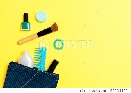 Make up products spilling out of cosmetics bag on 65331151