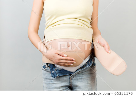 Close up of young pregnant woman dressing bandage Close up of young pregnant woman dressing bandage 65331176