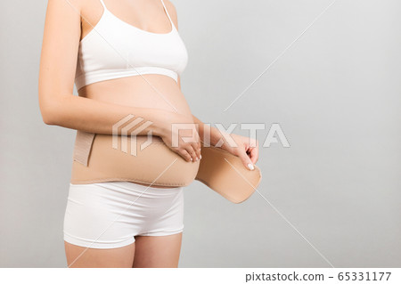 Cropped image of young pregnant woman in underwear Cropped image of young pregnant woman in underwear 65331177