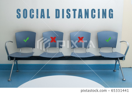 chair alignment in a waiting room with symbol on seat for the social distancing during the Covid-19 pandemic 65331441